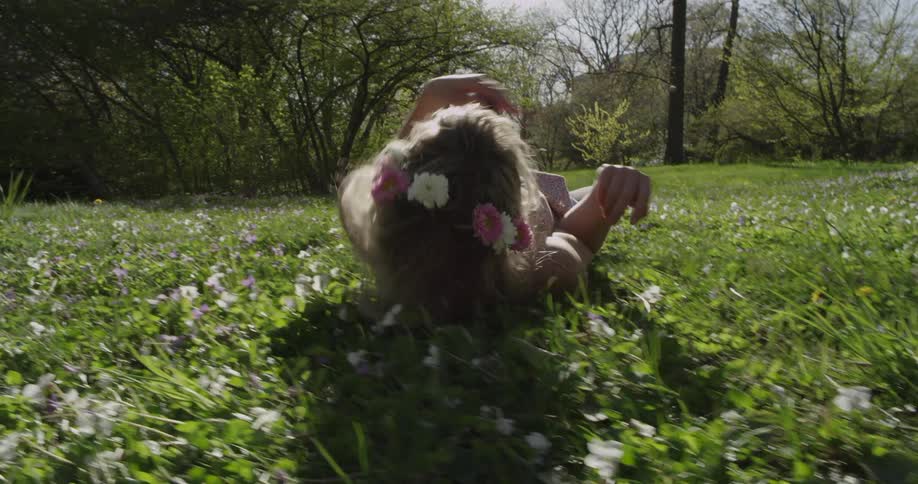 A girl rolling in the grass
