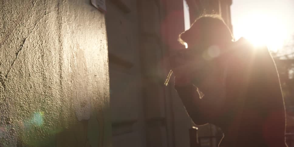 A man photographs an exterior wall