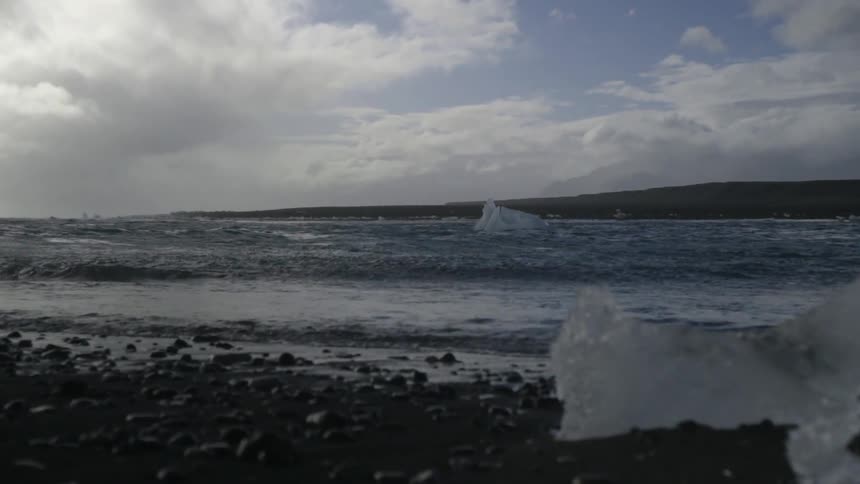 Waves wash up onto an icy beach