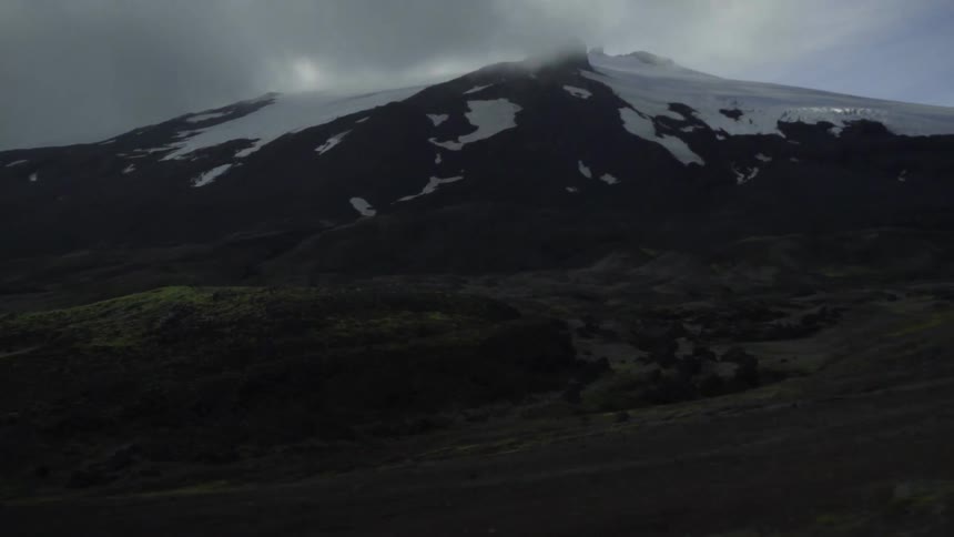 A wide angle shot of a snowy mountain landscape