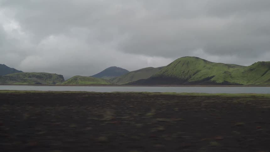 View of a lake from a rapidly moving vehicle