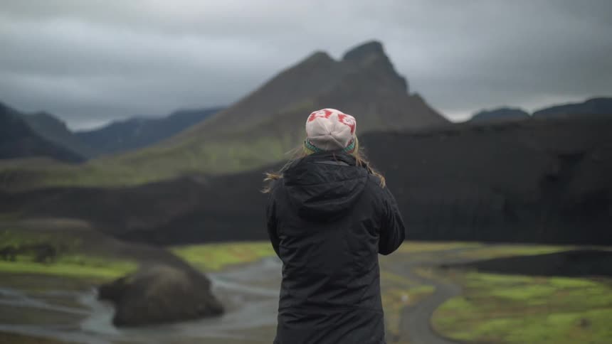 A person taking pictures of nature