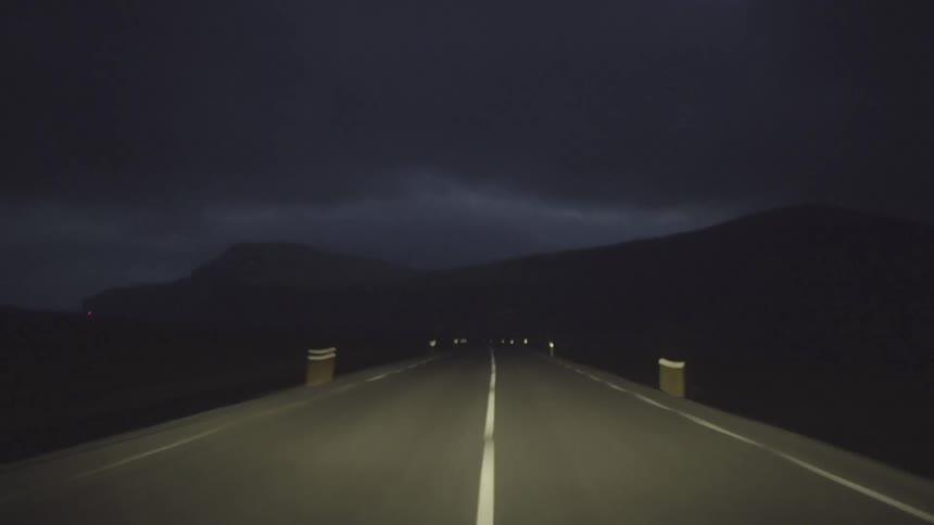 Driving fast down a road at night