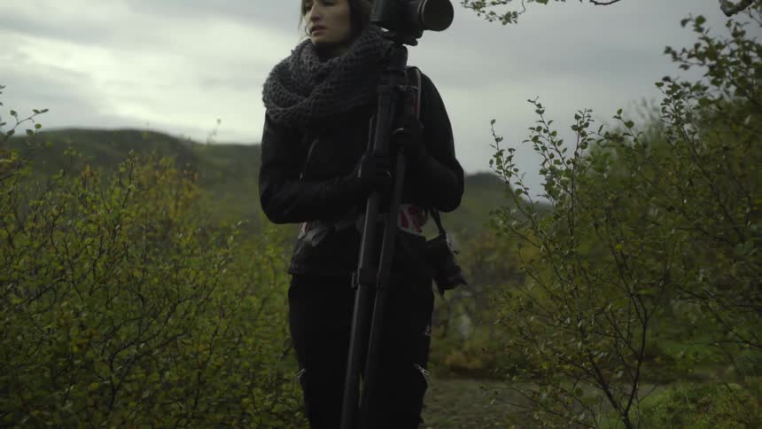 A person walking with a large camera