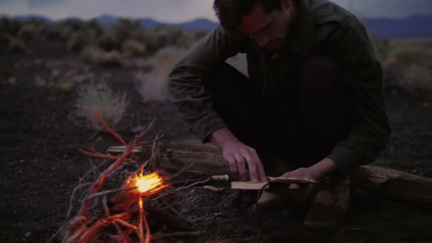 A person sitting by a campfire