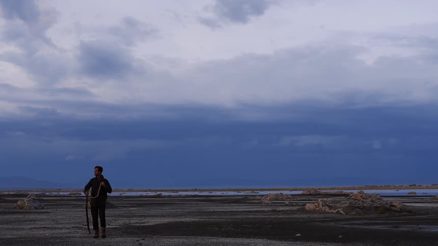 A man hikes through an open field