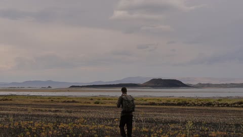 A hiker walks across an open field