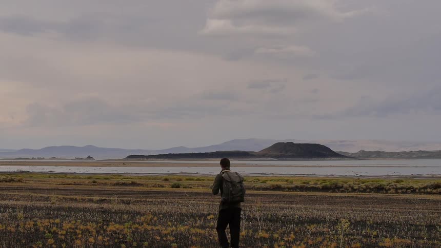 A hiker walks across an open field