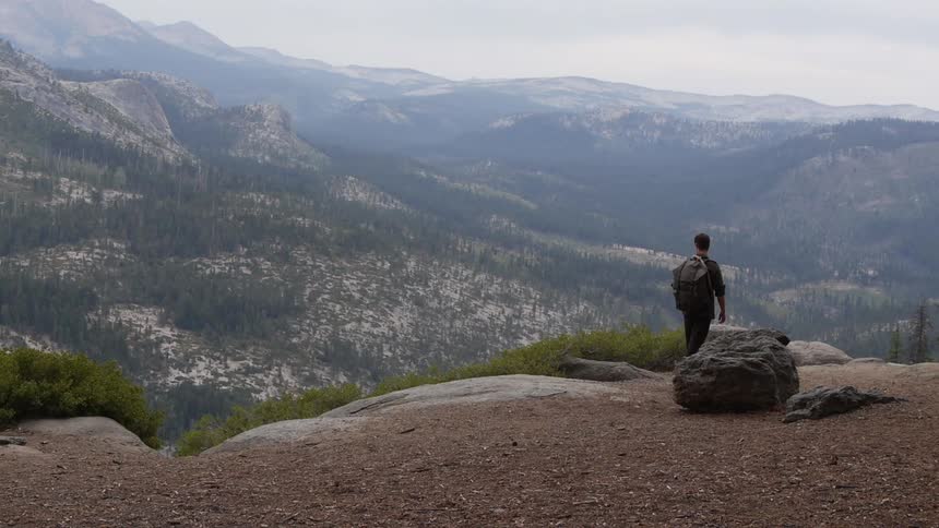 A hiker surveys the mountains