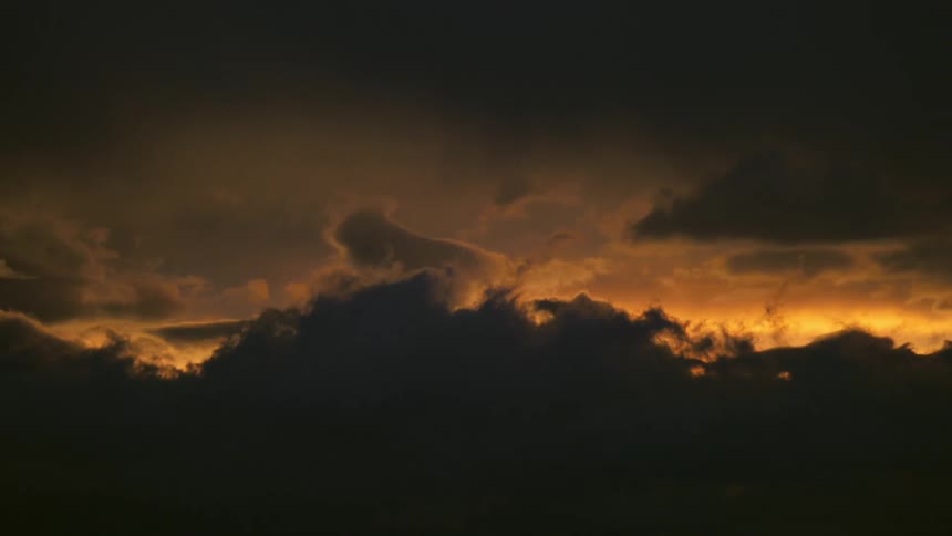 Clouds cover the sun as it sets