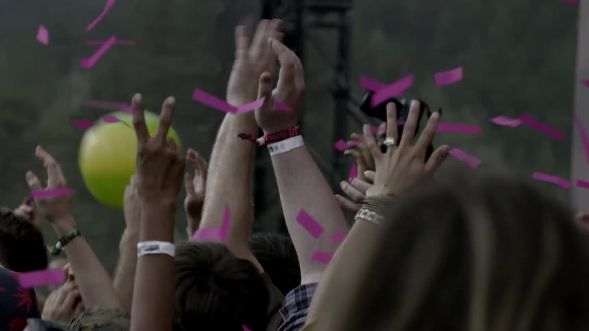 Confetti cascades over a cheering crowd