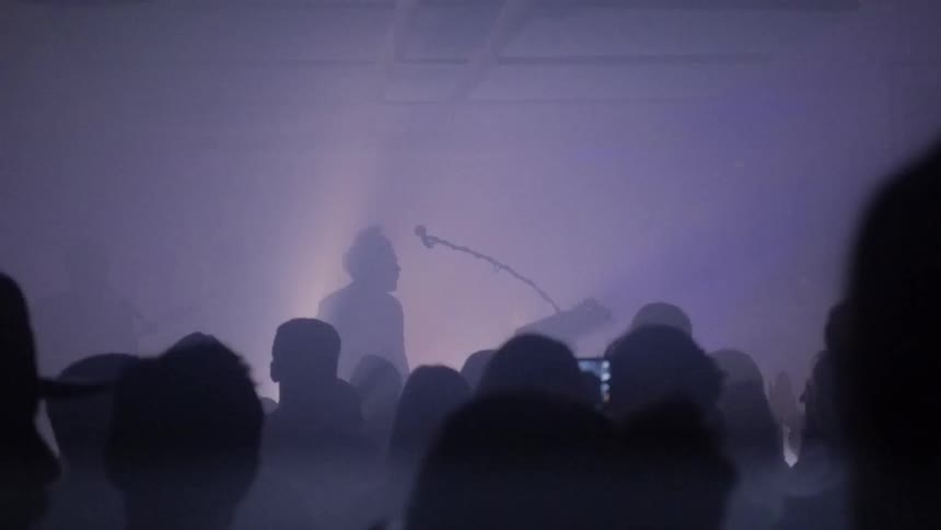 A crowded concert with flashing lights