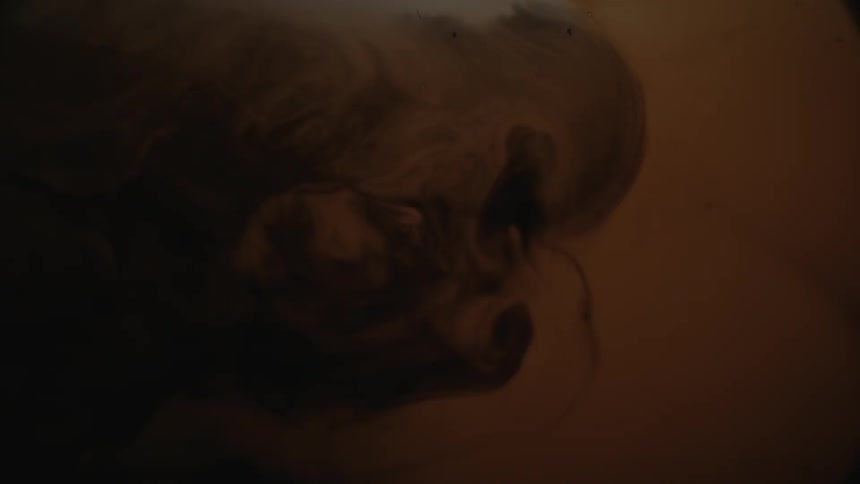 Black and brown liquid swirling together