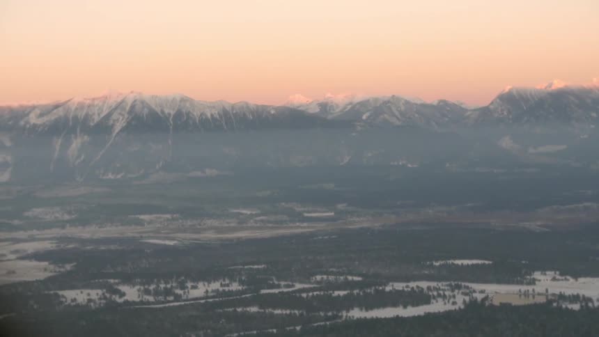 The sun sets over a mountain range