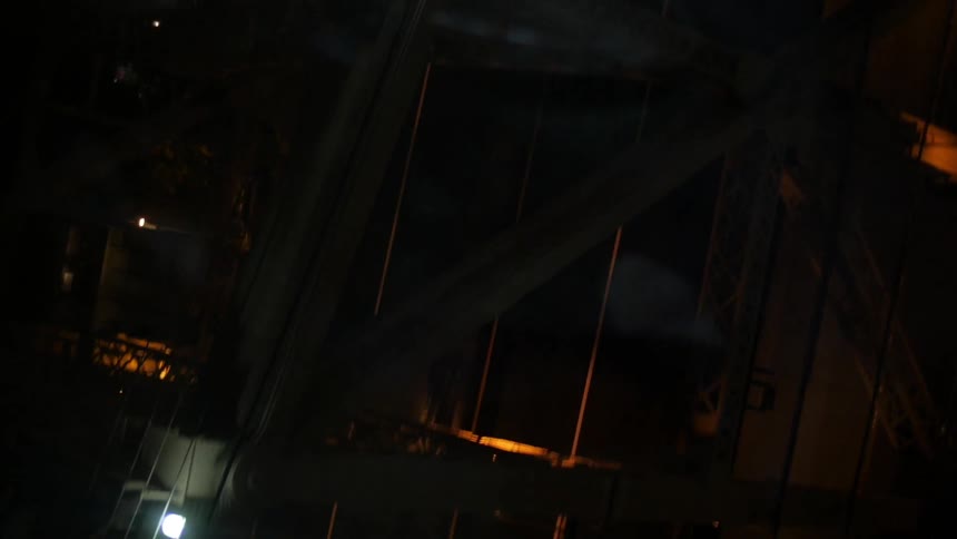 Traffic crossing a bridge at night
