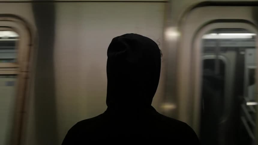 Man watches a train arriving at the subway station