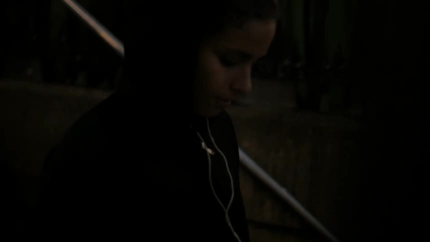 A woman walks down steps
