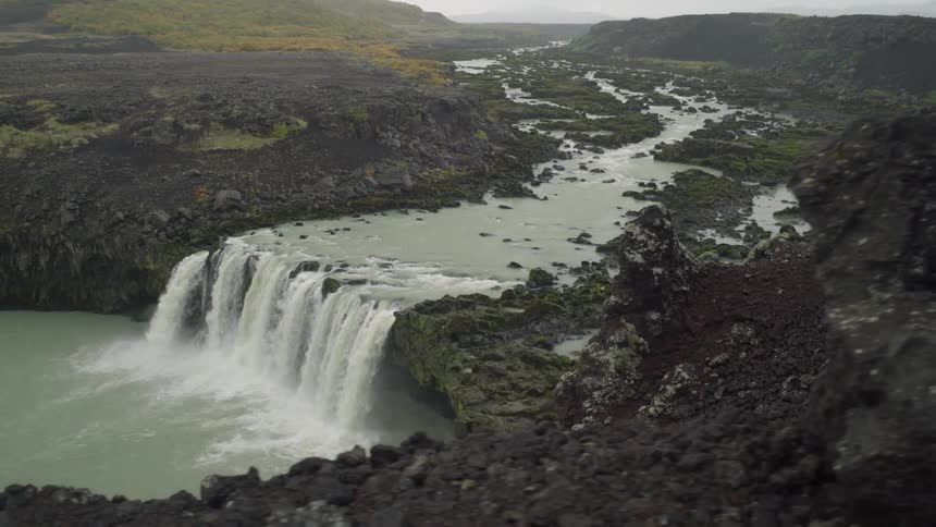 A waterfall cascades over a mountain