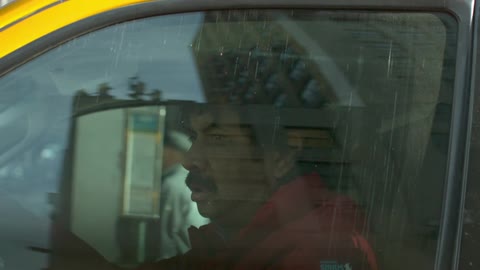 Man looking depressed sitting in a yellow car