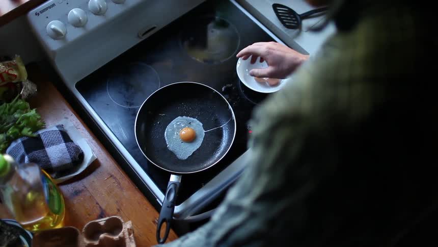A woman is preparing to cook