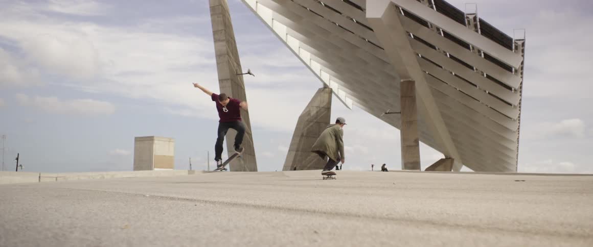 Men are skating in a park