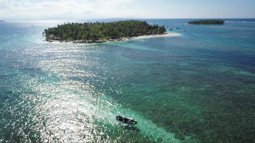 Aerial view of tropical waters along a coastline and small islands