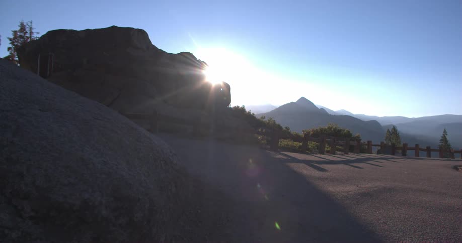 The sun comes up over a mountain