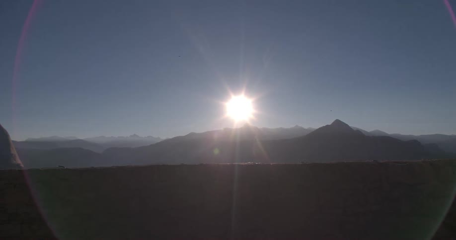 A view if the sun setting behind the mountains