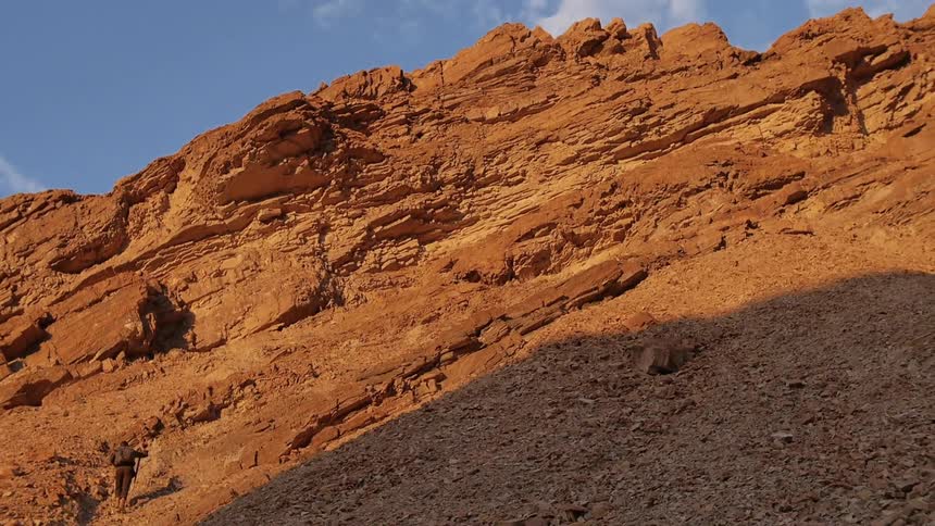 The person walks in the rocks