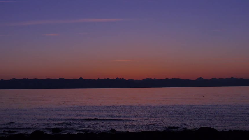 A sunset is shown amongst a shoreline
