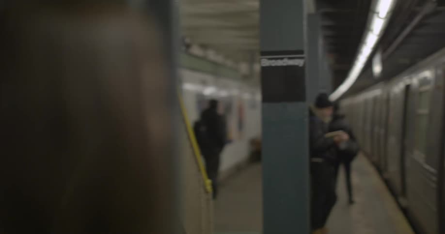 Woman waits and gets on the train in the subway station