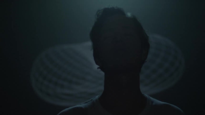 Man standing under a flashing light