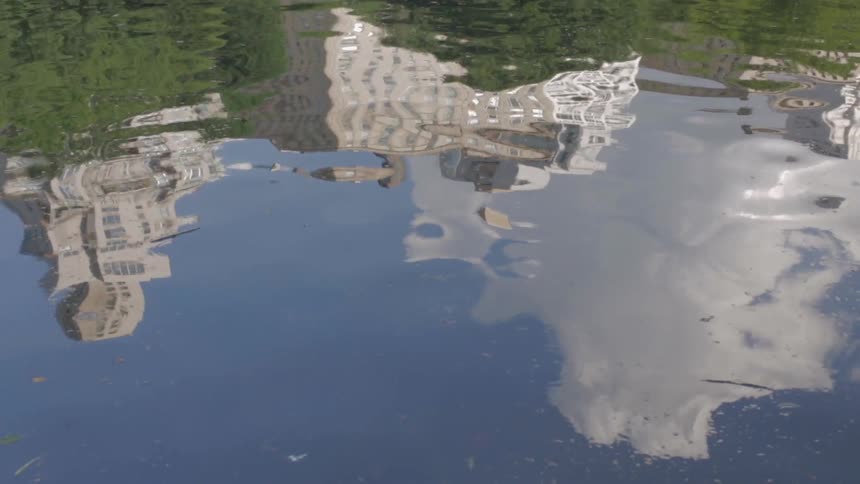 Water ripples and reflects some buildings