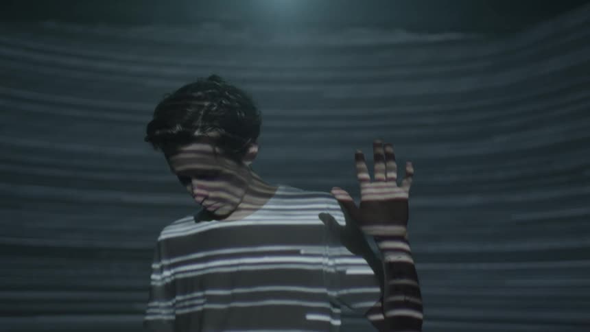 A man is playing with light at night