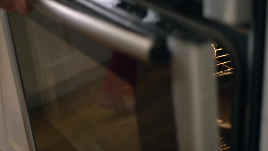 Two cake pans are placed into an oven