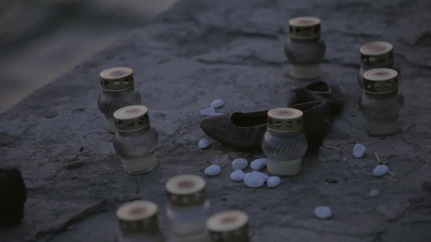 Trinkets rest at the water's edge