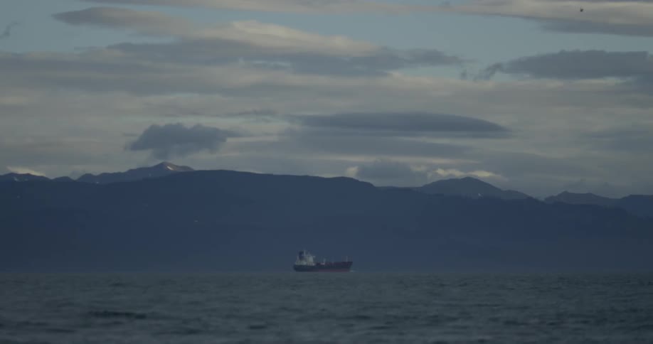 A boat slowly moves in the ocean