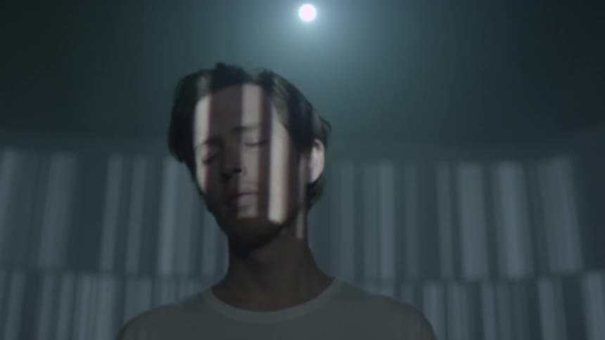 Lights flash on a man's face
