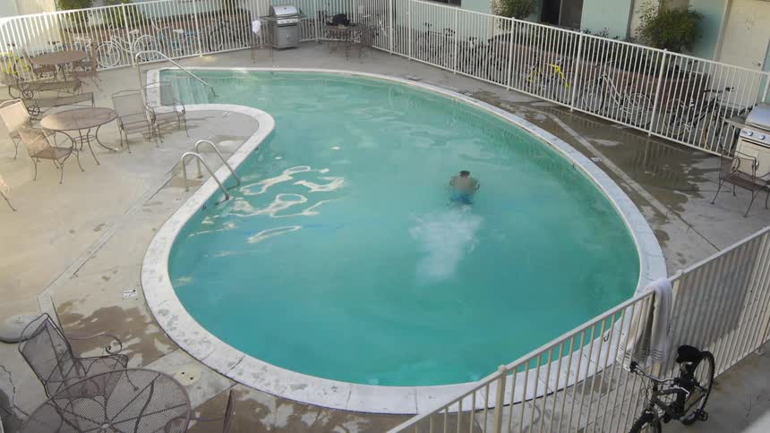 A man dives into a swimming pool