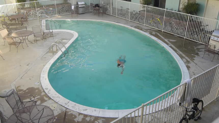 A man swims in a swimming pool