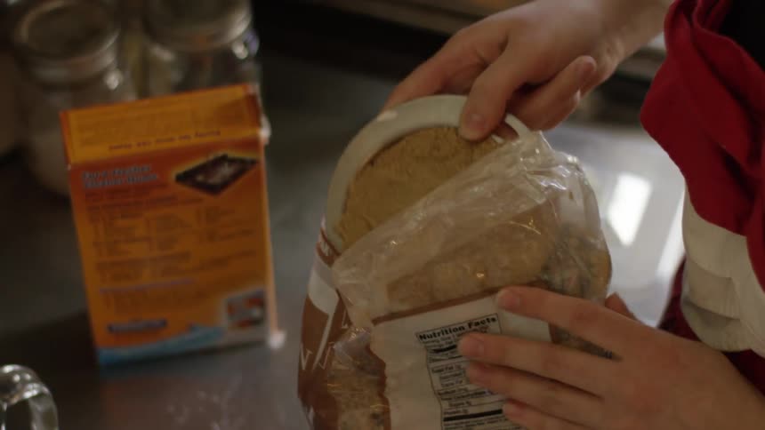 A mixer stands with butter inside