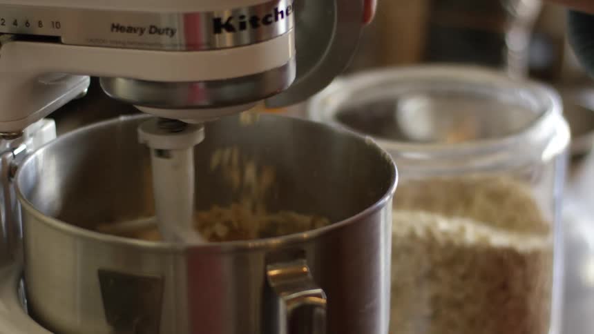 Pouring oatmeal into a mixer