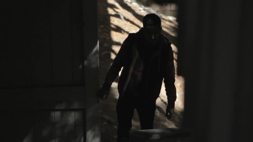 A man walks up a set of outdoor stairs