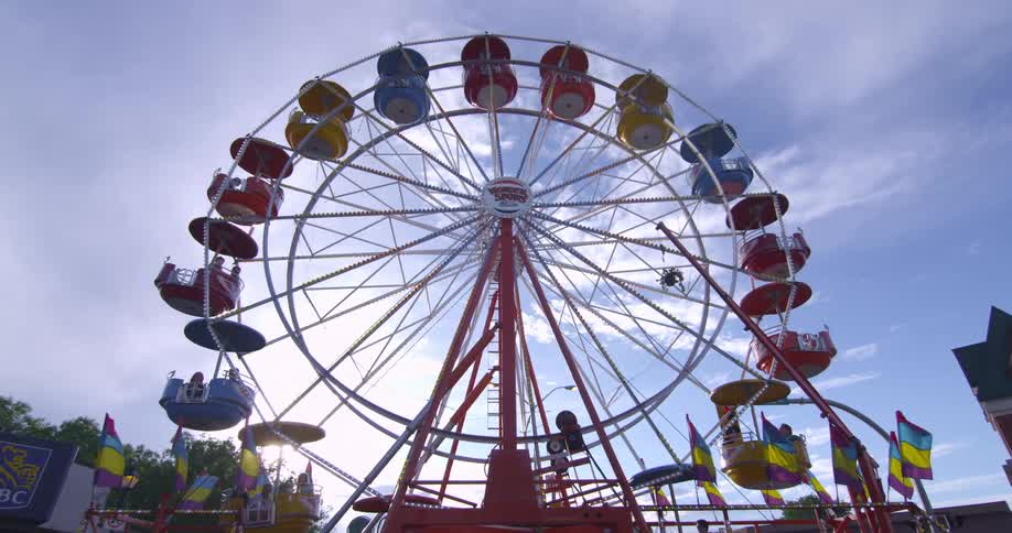 People are riding a ferris wheel during the day