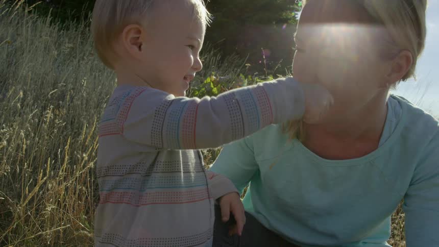 Baby gives mother some grass