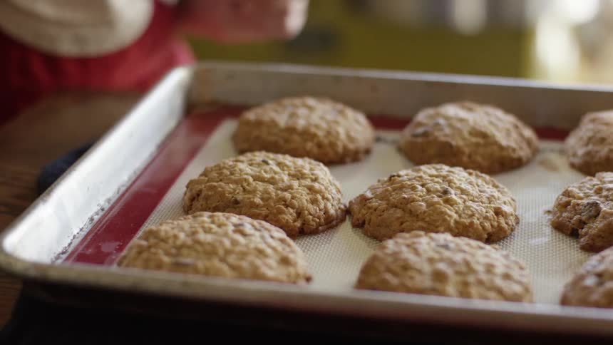 Pulling cookies from the oven