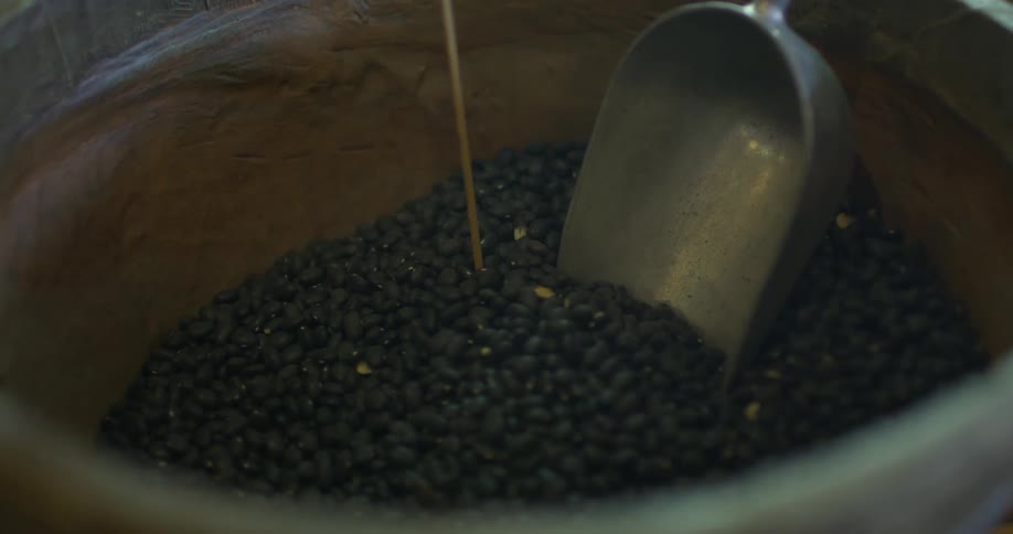 A scoop in a pot full of coffee beans