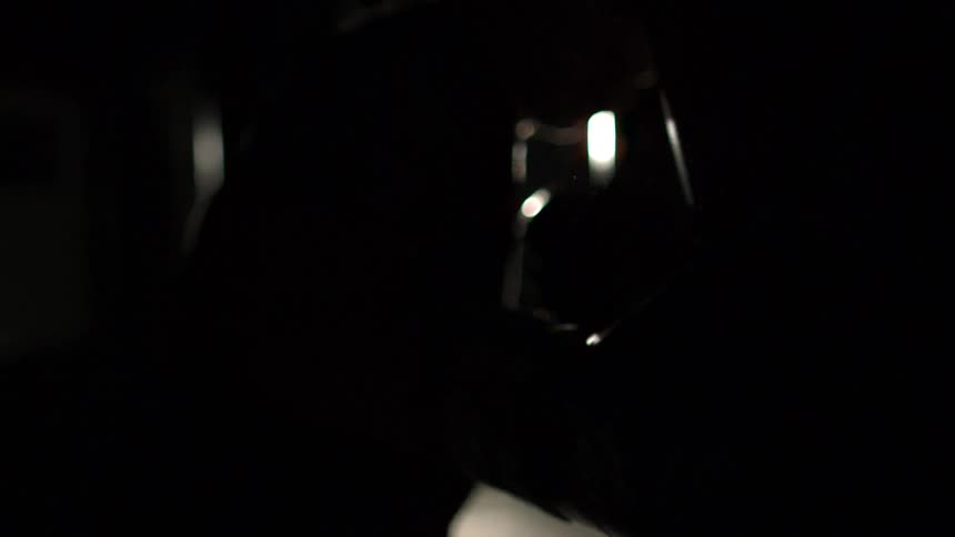Slow motion footage of a boxer punching a bag in a darkened gym