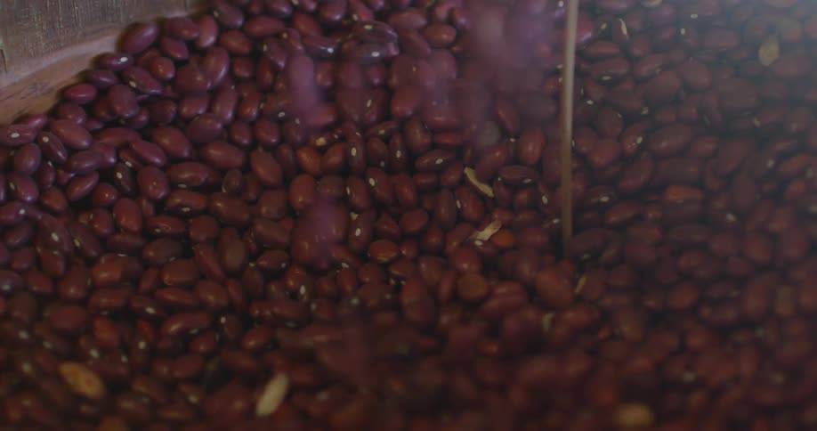 Red beans being poured into a container