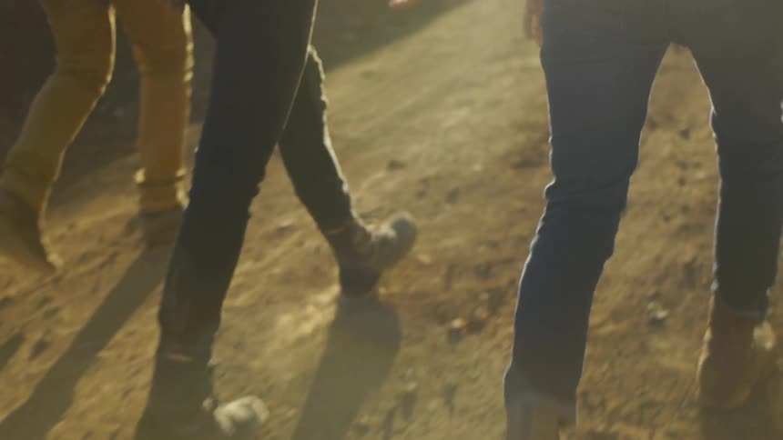 People walk along a dirt path